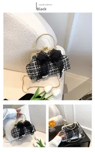 Detail of tweed crossbody bag featuring large black lace bow and pearl decoration