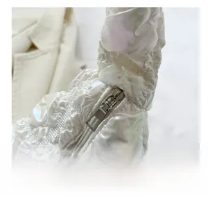 Close-up of the smooth metal zipper and iridescent quilted fabric on this puff shoulder bag