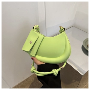 Detail of neon green crescent saddle bag with matching square pouch and knot strap