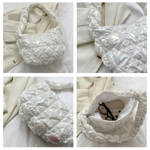 Macro shot showing holographic quilted fabric texture and spacious interior of puff bag