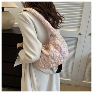 Detail of pink metallic quilted puffer shoulder bag with a crescent moon silhouette