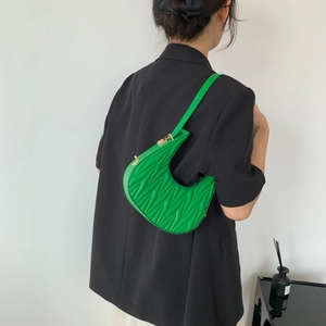 Green crescent shoulder bag featuring pleated matelassé stitching and metal clasp