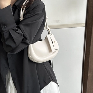 Minimalist off-white crescent crossbody bag with mini envelope pouch and knotted strap