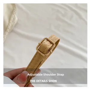 Detail of adjustable khaki leather strap with gold metal buckle and precision stitching
