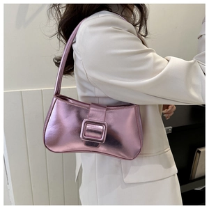 Close-up of metallic purple baguette bag with large square buckle shown on model