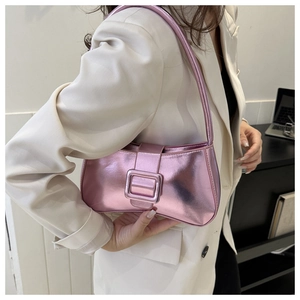 Close-up of metallic pink mirror leather shoulder bag with sleek square buckle detail