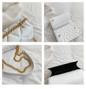 Detailaufnahme der weißen Stepptasche mit goldener Kette und dem schwarzen Innenfutter