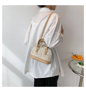 Straw shell bag featuring delicate floral embroidery and premium leather trim details