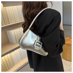Silver metallic leather hobo bag with large square buckle shown on a model
