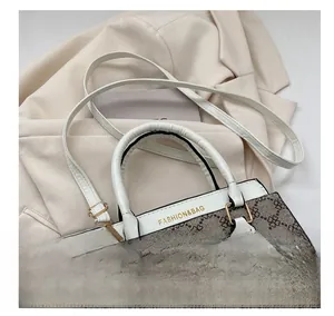 Detail view of vintage monogram handbag featuring white leather straps and gold hardware