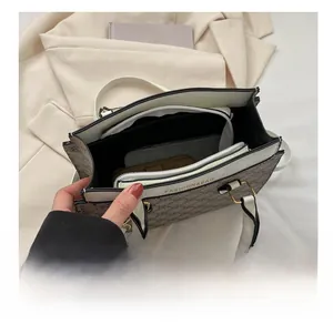 Internal view of fashion shoulder bag showing multiple compartments and storage capacity