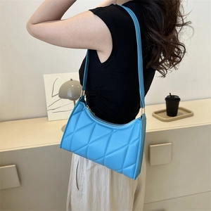 Sky blue quilted underarm bag for women with elegant stitching and slim shoulder strap