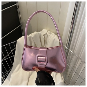 Close-up of metallic pink handbag featuring a large square buckle and Y2K aesthetic