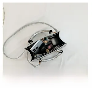 Top view showing the large interior capacity of this silver metallic crossbody bag