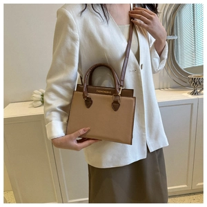 Minimalist beige and brown crossbody bag shown with professional casual attire