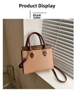 Detail view of khaki and brown two-tone PU leather handbag with gold-tone hardware