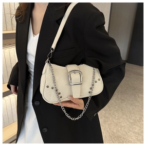 Detail of white canvas underarm bag with silver square buckle and metallic chain strap