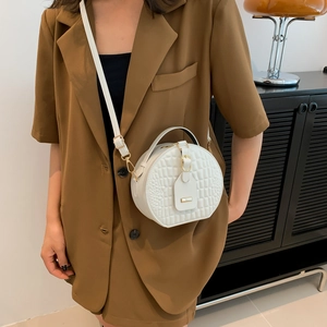 White round crossbody bag with crocodile texture and gold hardware for women