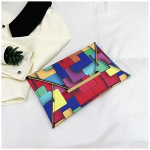 Detail of colorful geometric patchwork clutch bag with golden metallic top closure