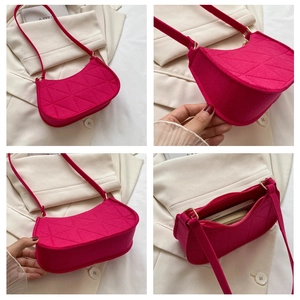 Detail view of fuchsia felt hobo bag with geometric quilting and gold hardware accents