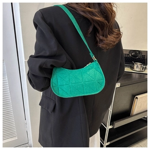 Detail of green crescent underarm bag with triangle quilting and gold adjustable buckle