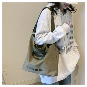 Detail of olive green canvas tote bag with FASHION BAG print and adjustable strap