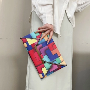 Modern colorful geometric patchwork envelope clutch bag with elegant gold metal trim