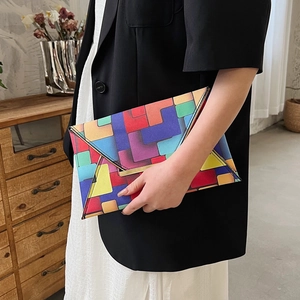 Fashionable geometric color-block envelope clutch bag with golden metal hardware detail