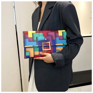 Dettaglio pochette arcobaleno con grande fibbia in metallo dorato e stampa geometrica