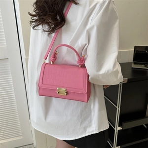 Pink vintage crossbody bag with crocodile texture and gold clasp, modeled for size visual