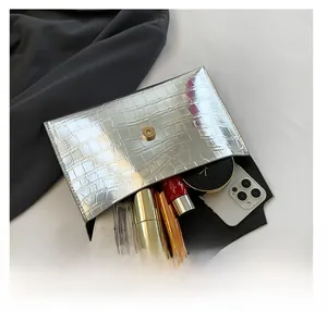 Silver crocodile texture clutch bag showing internal space for phone and makeup