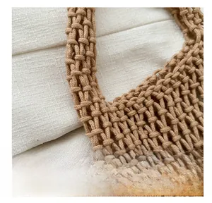 Detail of woven khaki mesh handbag showing premium knot craftsmanship and texture