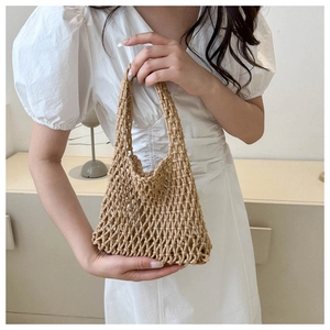 Detailed close-up of handmade khaki woven tote bag with retro hollow grid structure
