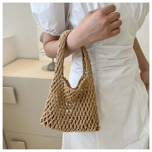 Detailed close-up of handmade woven mesh handbag in beige cotton rope with minimalist style