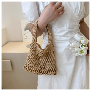 Detail of hand-woven woven tote bag in khaki with unique texture and white tulip decoration