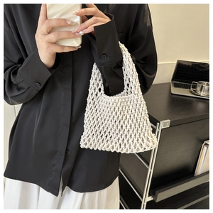 Chic cream woven mesh tote bag shown as a stylish accessory for modern women outfits