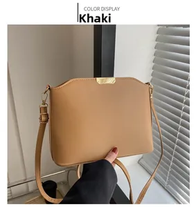 Close-up of khaki matte PU leather crossbody bag with golden metal hardware and strap