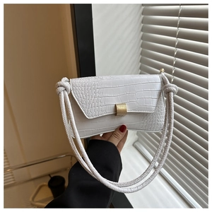 Detailed macro shot of white crocodile-textured leather with golden metal lock buckle