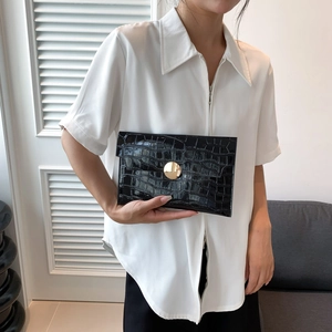 Elegante borsa a busta nera con stampa coccodrillo e fibbia circolare dorata