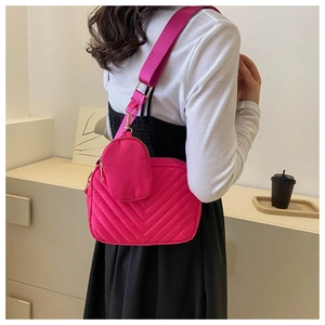 Dettaglio borsa a tracolla trapuntata rosa con mini portamonete coordinato sulla tracolla