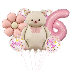 Detail of pink number 6 balloon with beige bear and floral party decorations