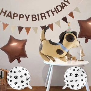 Dog themed party set with spotted puppy foil balloon and paw print decorations
