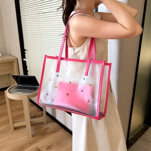 Fashionable pink sequin tote bag and inner pouch shown in a warm home office setting