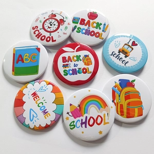 Detailed flat lay of 8 back to school tinplate badges with colorful school icons