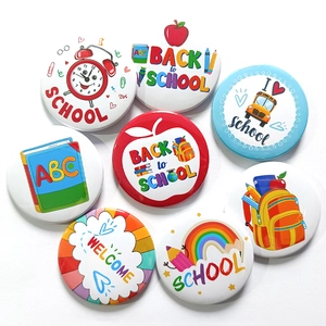 Close-up of 8-piece Back to School tinplate badges with colorful school bus and pencil icons