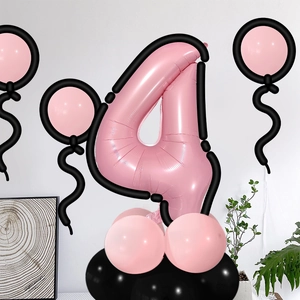 Close-up of pink number 4 balloon kit with black latex base for birthday party decor