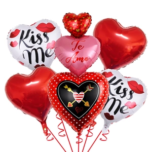 Detail of heart-shaped foil balloons featuring Kiss Me and Te Amo prints for Valentines