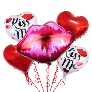Detail of red lips and heart foil balloons with Kiss Me print for Valentine decor