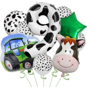 Detail of 9th birthday farm party set with cow print balloons and green tractor