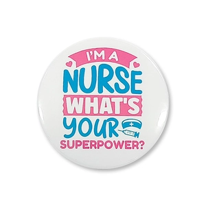 Detailed view of tinplate nurse badge with 'I'M A NURSE' text and medical icons